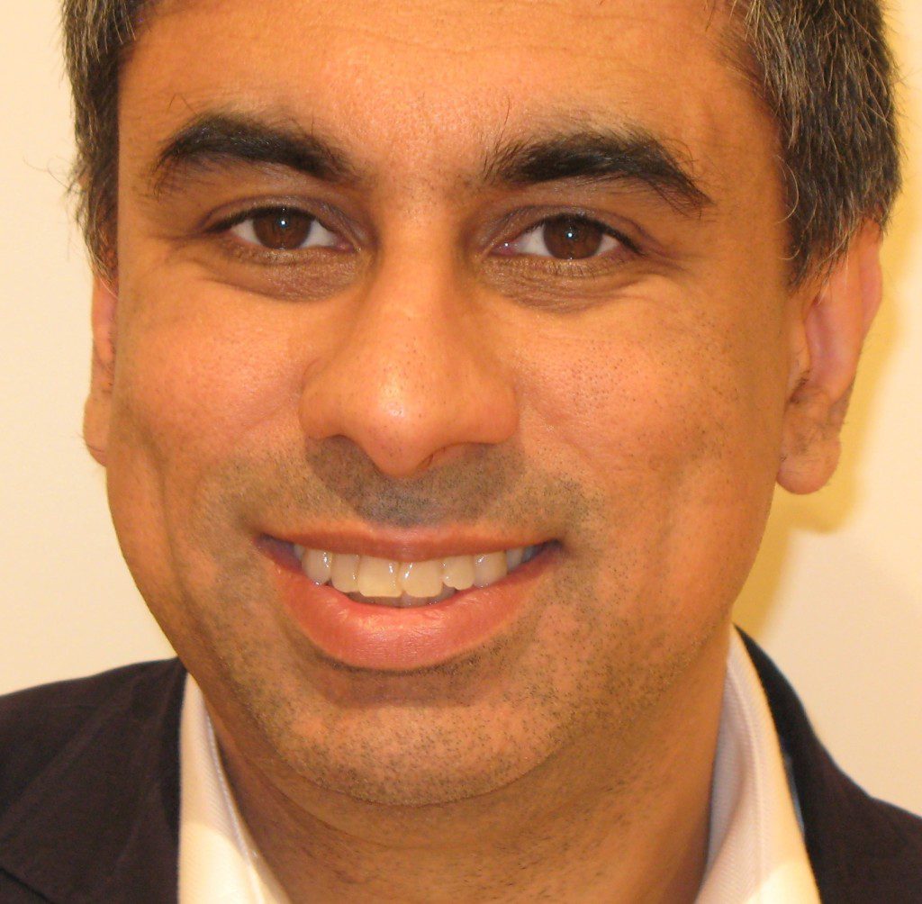 A professional man smiling into the camera