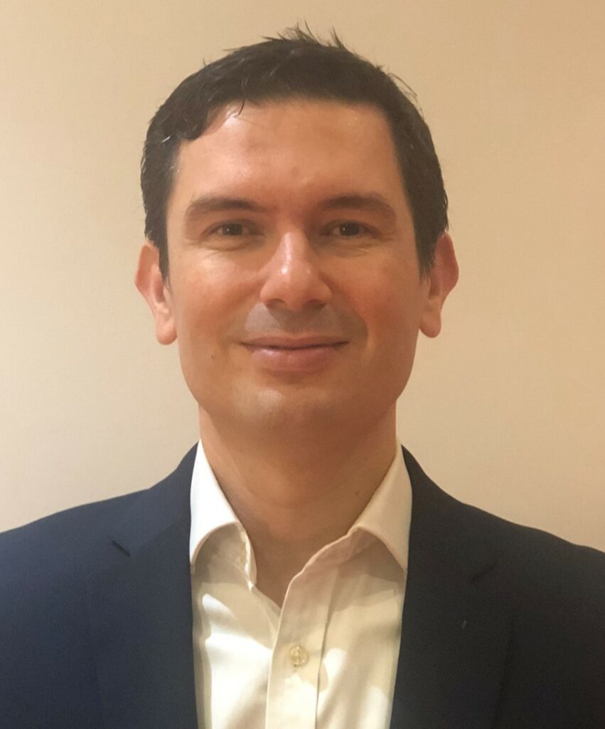 A professional man smiling into the camera