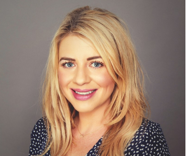 Headshot of woman smiling in a polka dot top