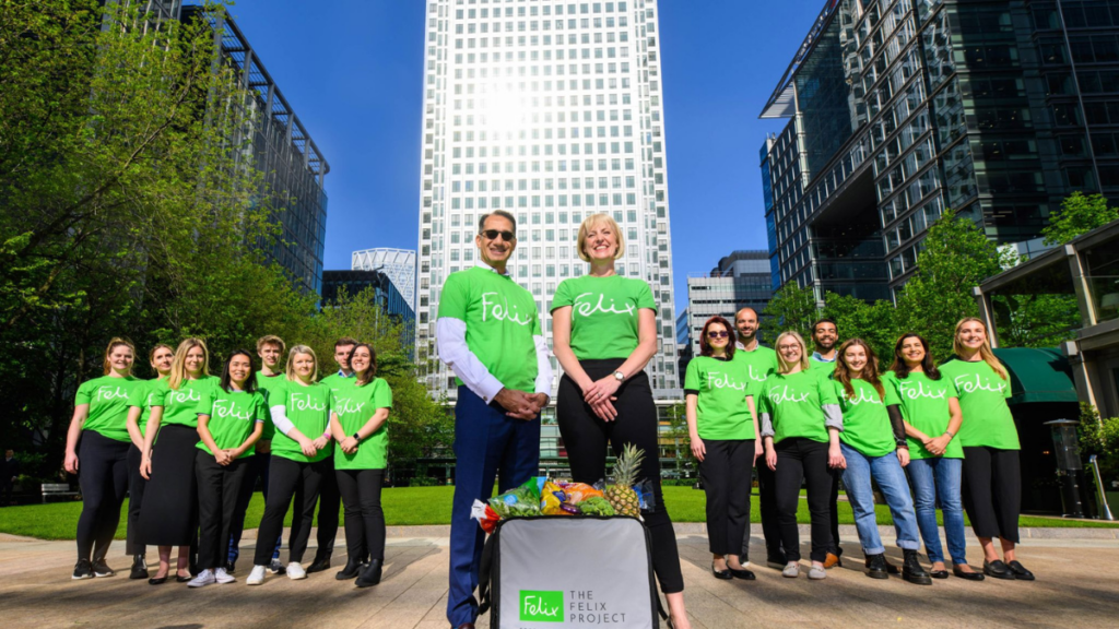 A group of people in green T-shirts standing together for the felix project